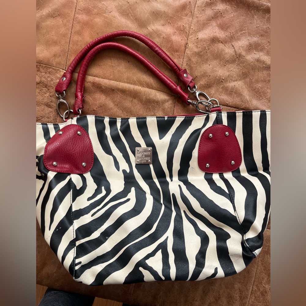 Zebra with red handles tag says Dooney and Bourke. No interior tag.